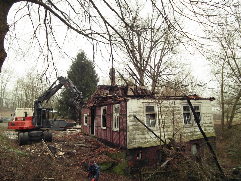 Präziser Rückbau mit Sortiergreifer an der Giebelseite der Brandruine